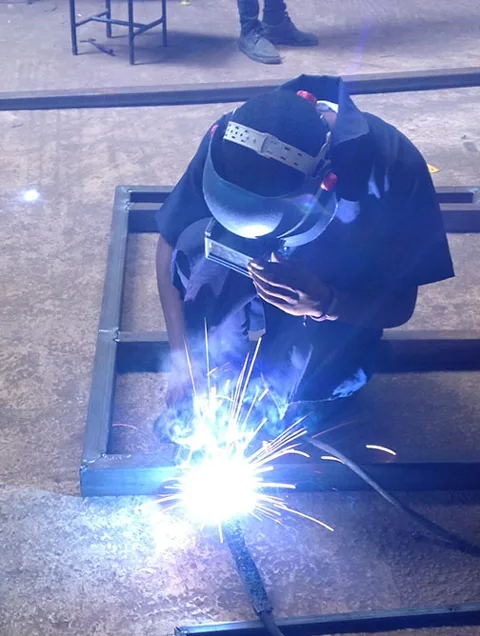 Student welding in the workshop