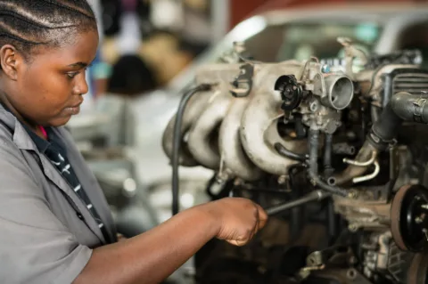 Mechanics trainee working on an engine